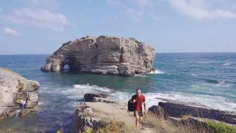 Traveler-man-walking-on-cliffs-by-the-sea.